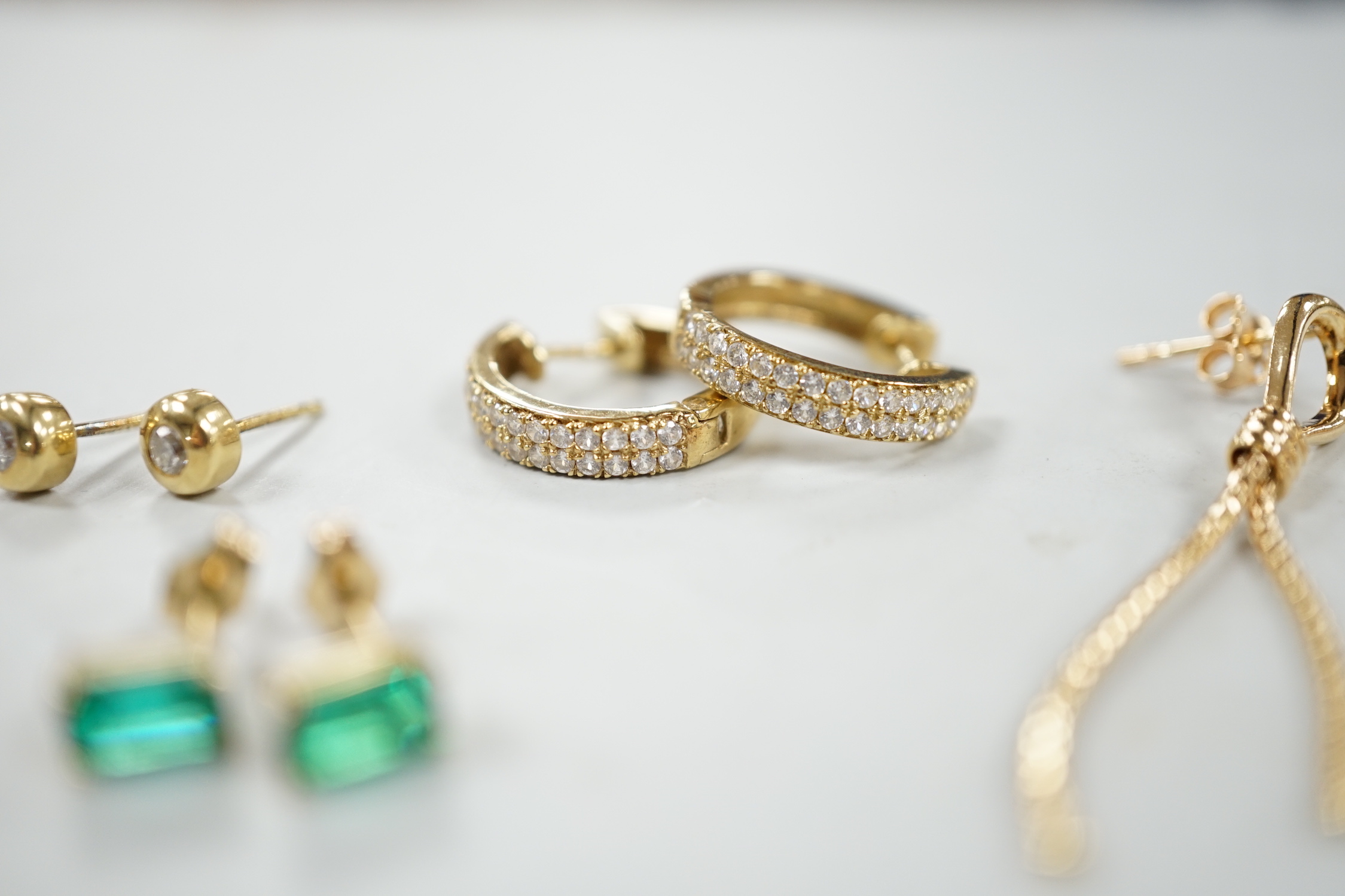 A modern pair of 18ct gold and collet set diamond ear studs, 5mm, two pairs of 9ct earrings (gross 4.5 grams) and a pair of 14k and green stone set ear studs.